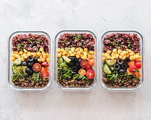 Three containers of food with different ingredients in them.